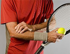 Tennis player holding his elbow